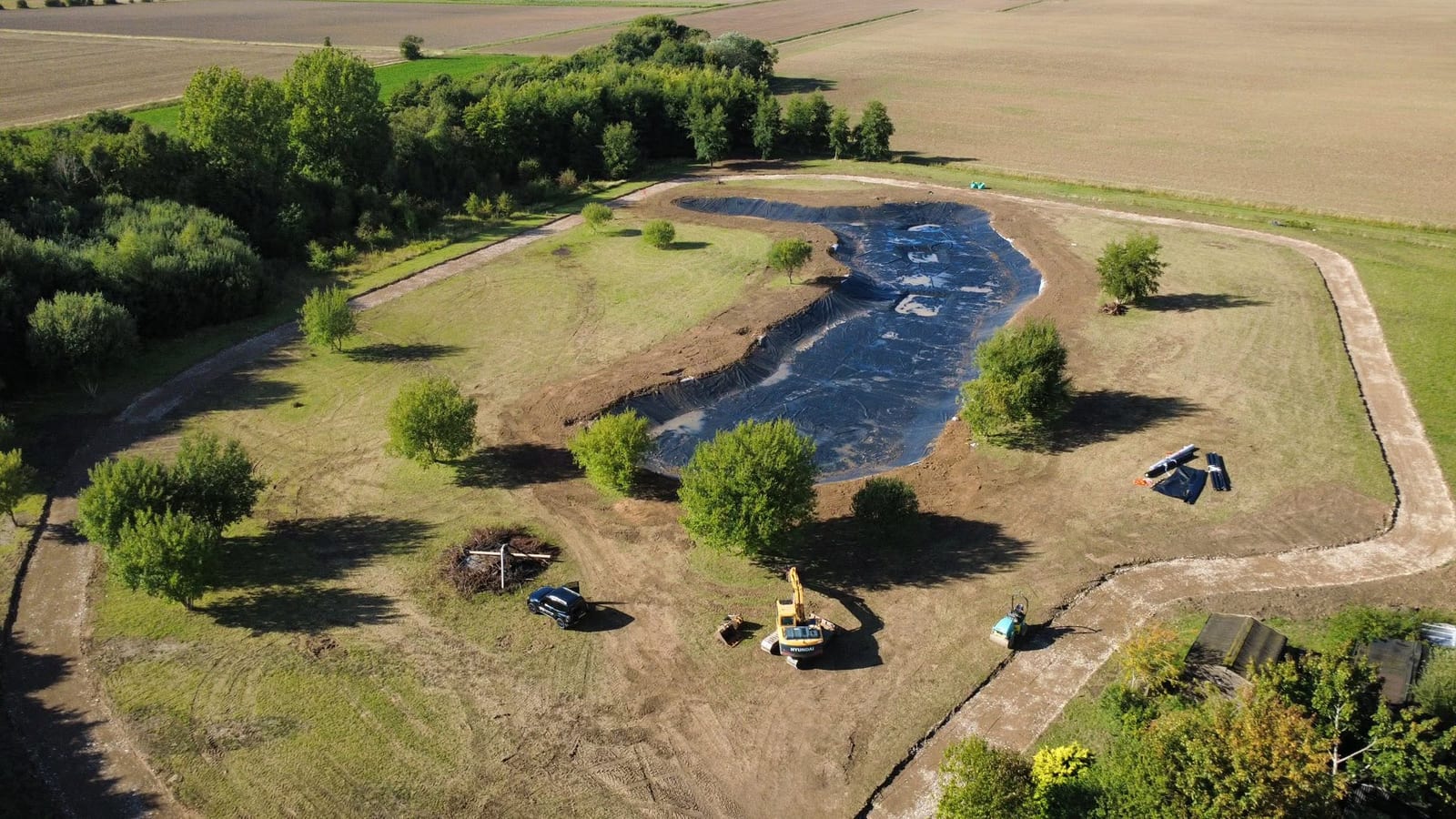 Excavator working the bank of a new lake, by J.E. Jones, groundworks and earthworks contractors, Lincolnshire