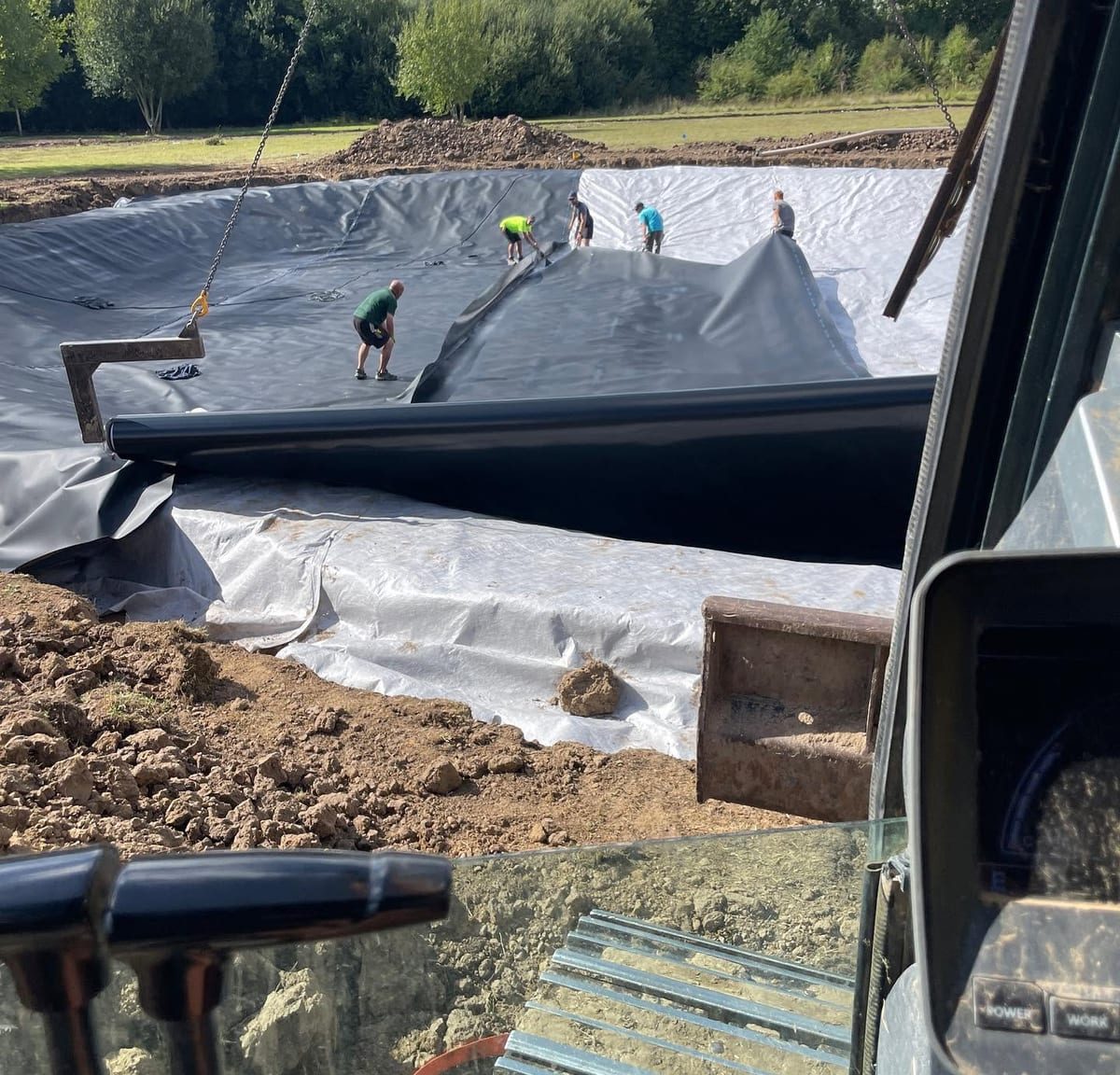 Liner being drawn out over the excavated base, by J.E. Jones, groundworks and earthworks contractors, Lincolnshire